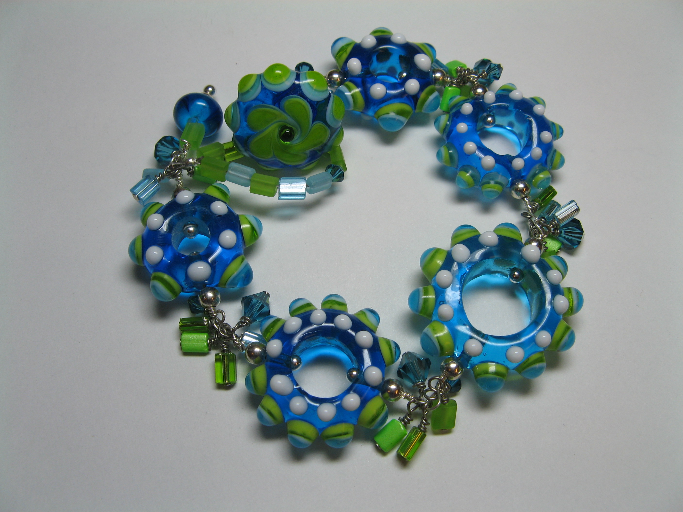 Bright blues and greens with a hand made button toggle